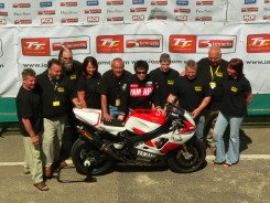 Members of a winning TT racers' team pose for their victory shot